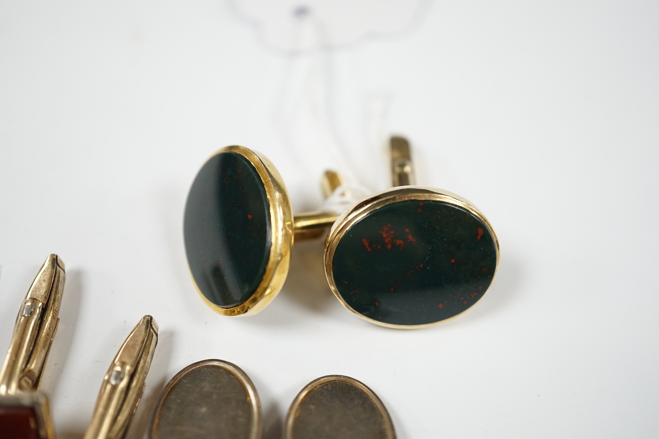 A modern pair of 9ct gold and bloodstone set oval cufflinks, 23mm, gross weight 12.6 grams, together with three other pairs of cufflinks including silver and 'gold on silver'. Condition - fair to good